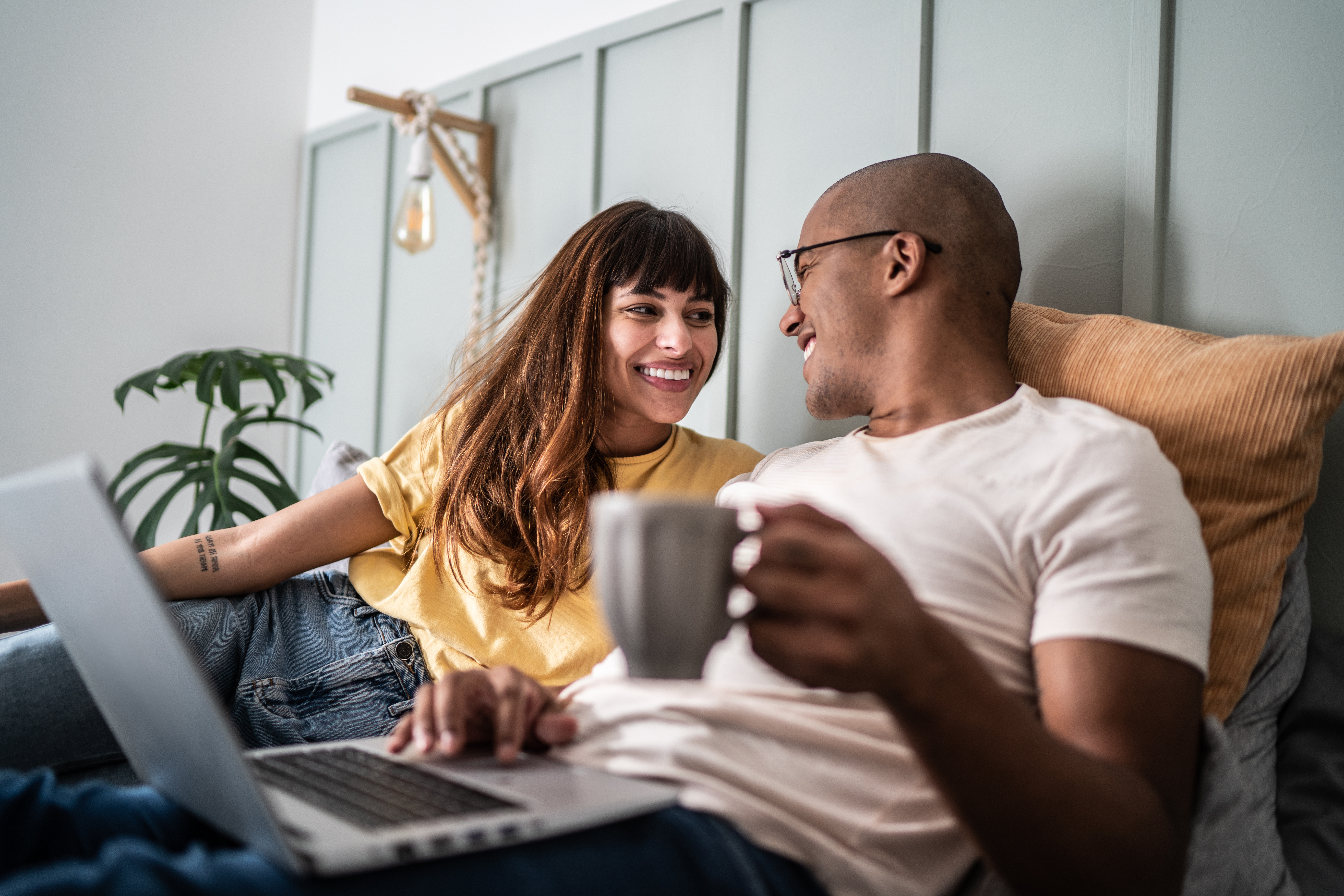 man and woman looking at computer